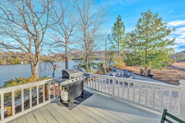 deck with a grill and a water view