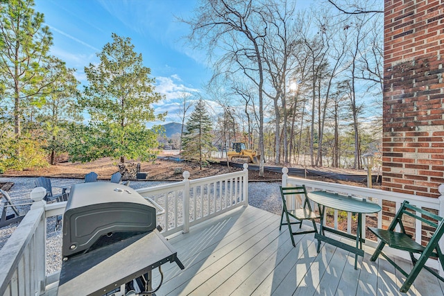 wooden terrace with a grill and a mountain view