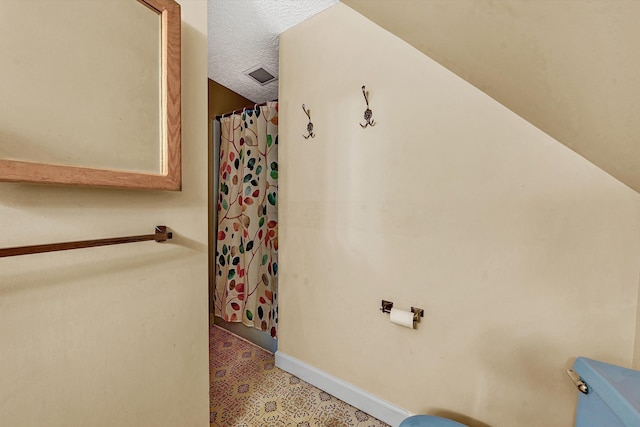 bathroom featuring tile patterned floors, visible vents, a shower with curtain, and baseboards
