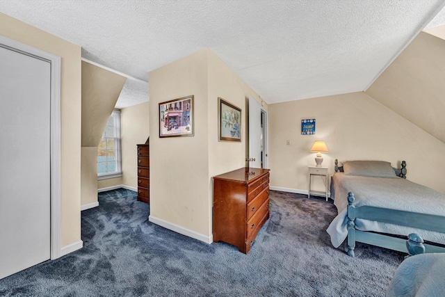 carpeted bedroom featuring a textured ceiling and vaulted ceiling