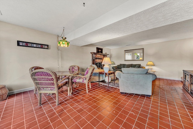 tiled living room featuring a textured ceiling and a fireplace