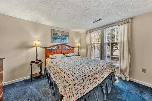 carpeted bedroom with a textured ceiling