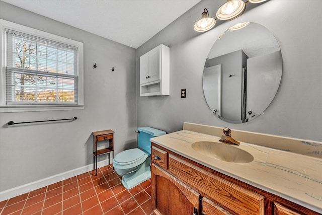 bathroom with toilet, vanity, and tile patterned floors