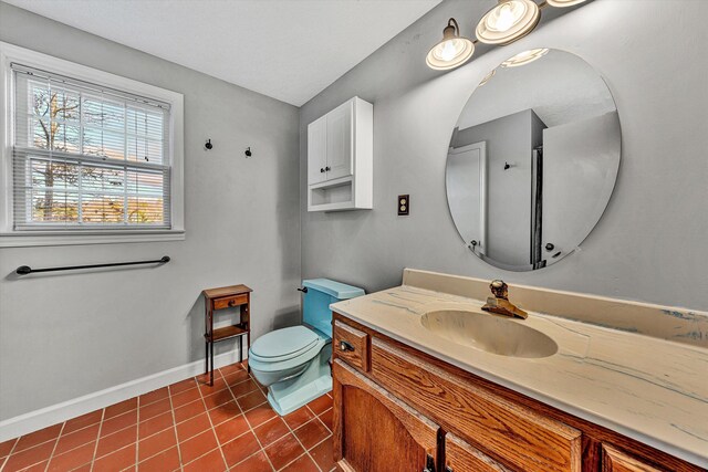 bathroom featuring baseboards, toilet, tile patterned flooring, and vanity
