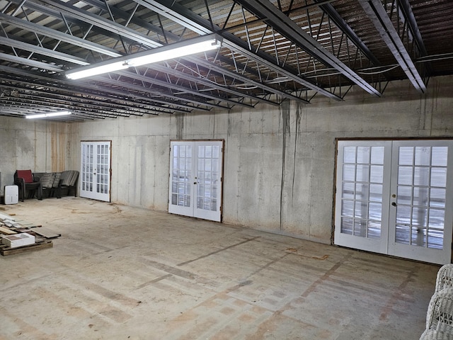 interior space with french doors and concrete flooring