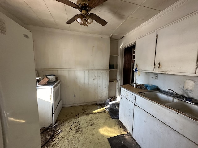 kitchen featuring sink, ceiling fan, concrete flooring, white cabinets, and washer / clothes dryer