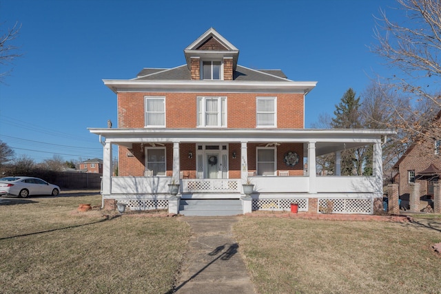 farmhouse featuring a front yard and a porch