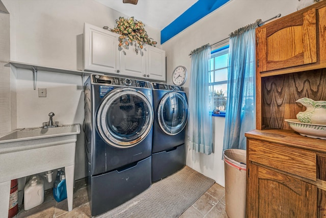 laundry area featuring washing machine and clothes dryer and cabinets