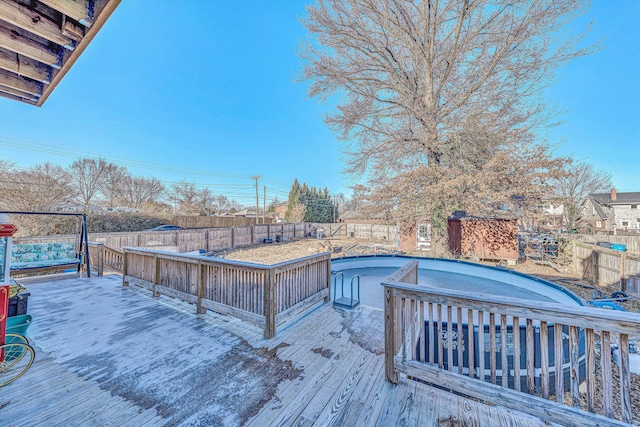 deck featuring a fenced in pool