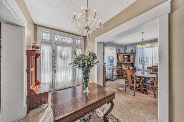 interior space with a textured ceiling, a healthy amount of sunlight, and a notable chandelier