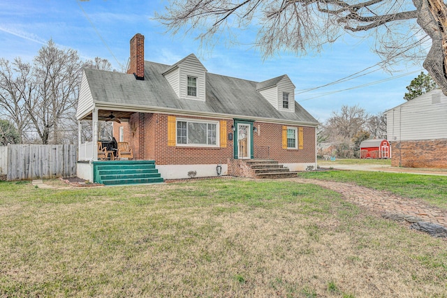 new england style home featuring a front lawn