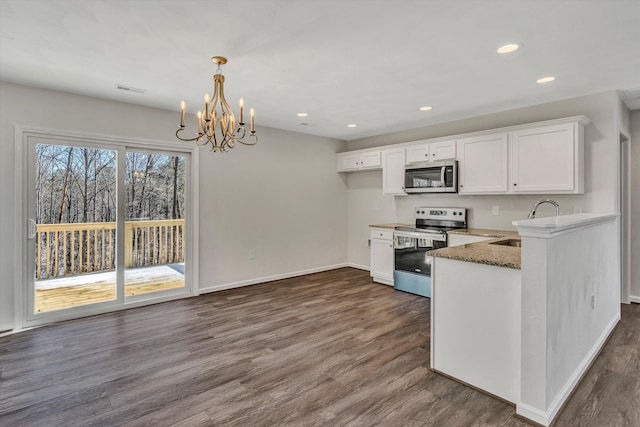 kitchen featuring stainless steel appliances, white cabinetry, a sink, and dark wood-type flooring