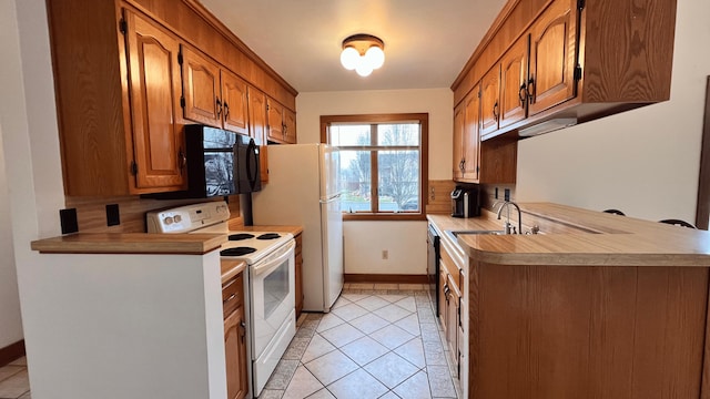 kitchen with sink, light tile patterned floors, and black appliances