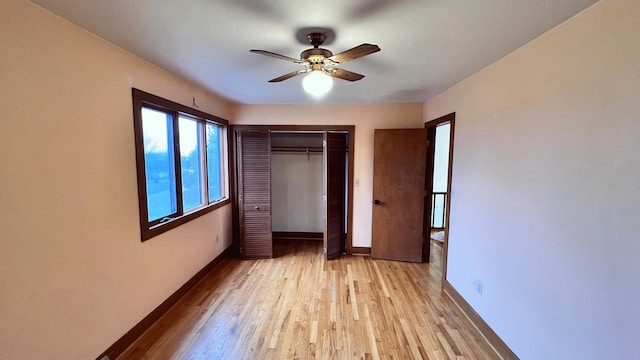 unfurnished bedroom featuring ceiling fan, light wood-type flooring, and a closet