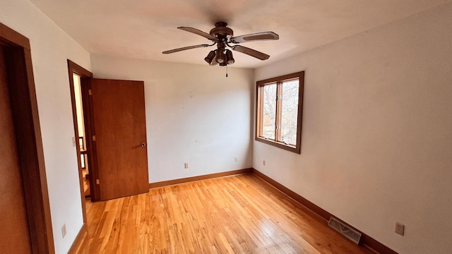 empty room featuring light wood-type flooring and ceiling fan