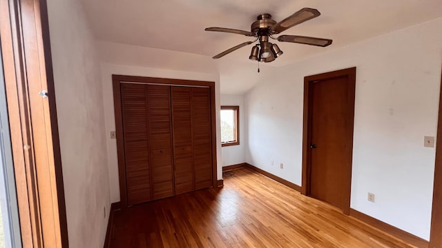 unfurnished bedroom with ceiling fan and light hardwood / wood-style flooring