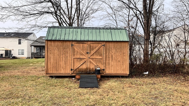 view of outbuilding with a yard