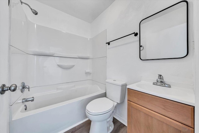 full bathroom featuring vanity, hardwood / wood-style flooring, tub / shower combination, and toilet