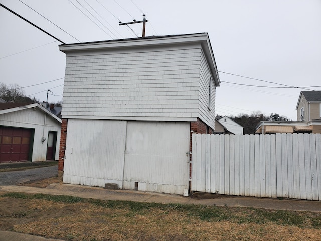 view of home's exterior with an outbuilding