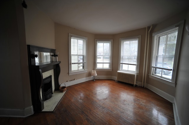 living room with radiator and dark wood-type flooring