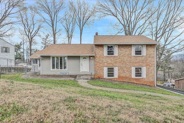 split level home featuring a front lawn