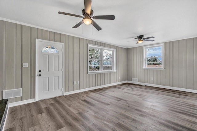 entryway featuring hardwood / wood-style floors, plenty of natural light, ornamental molding, and ceiling fan