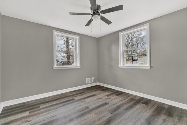 spare room with ceiling fan and dark hardwood / wood-style flooring