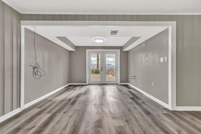 entryway featuring crown molding, french doors, and wood-type flooring