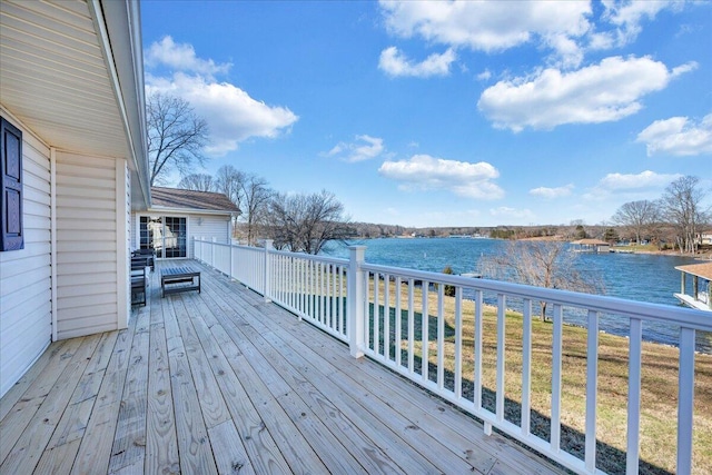 wooden deck featuring a water view