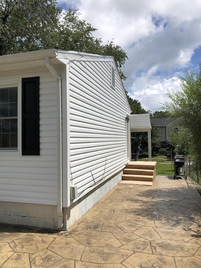 view of side of property with a patio area