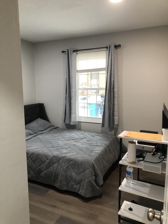 bedroom with dark hardwood / wood-style floors