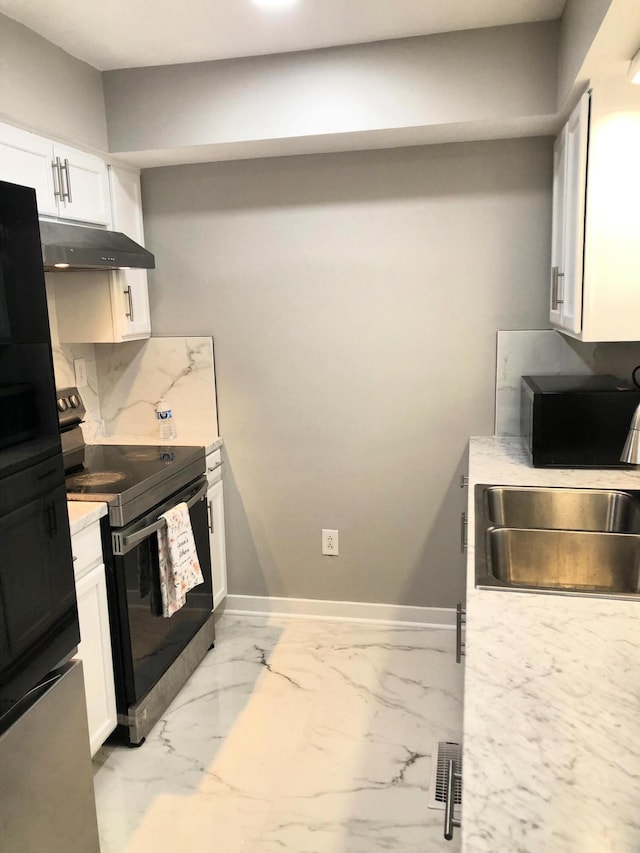 kitchen with backsplash, black electric range, white cabinets, and sink