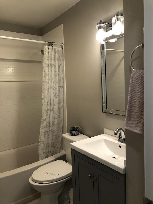 full bathroom with shower / bath combo, vanity, and toilet