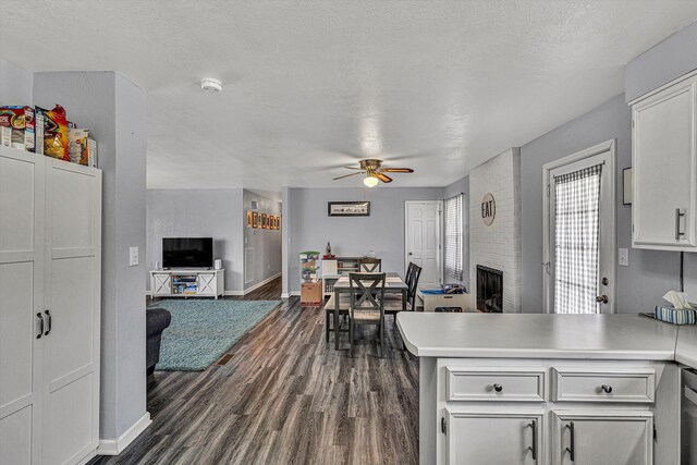 kitchen featuring stainless steel appliances, white cabinets, kitchen peninsula, and sink