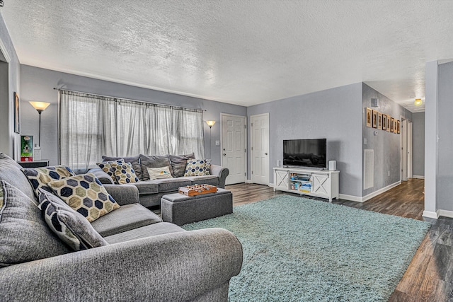 living room featuring a textured ceiling and dark hardwood / wood-style floors