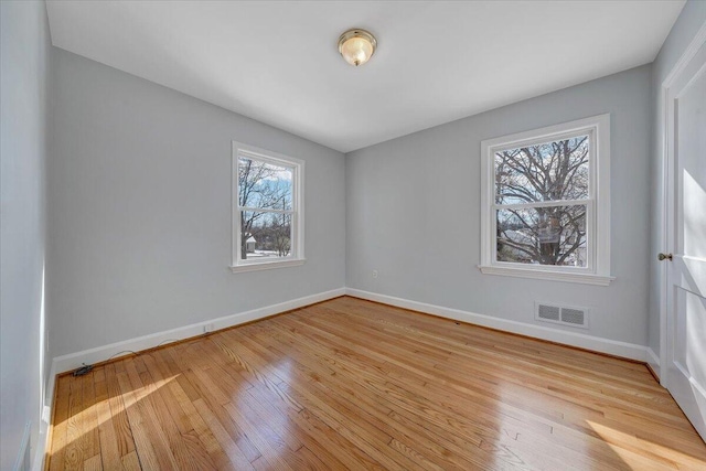 spare room featuring light hardwood / wood-style floors