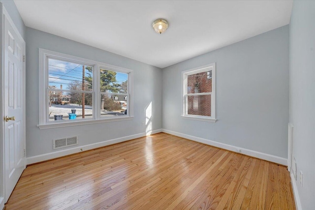 empty room with light hardwood / wood-style flooring