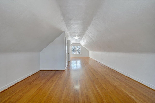 bonus room featuring light hardwood / wood-style floors and lofted ceiling