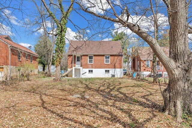 snow covered house featuring central AC