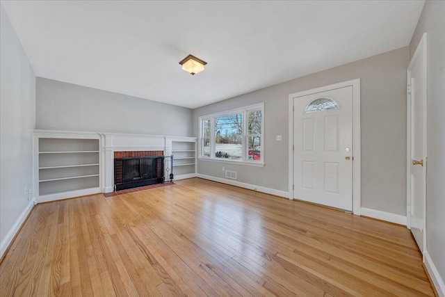 unfurnished living room with light hardwood / wood-style floors and a fireplace