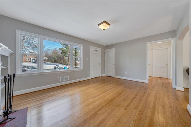 unfurnished living room featuring light wood-type flooring