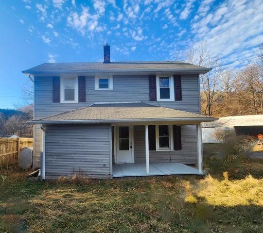 back of house featuring a patio area and a yard