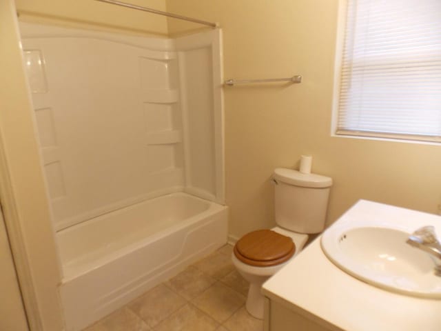 full bathroom with toilet, vanity,  shower combination, and tile patterned floors