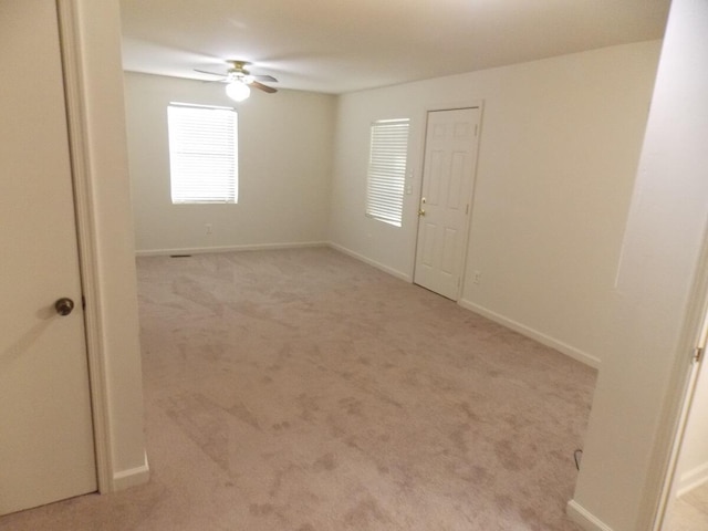 empty room with light carpet and ceiling fan