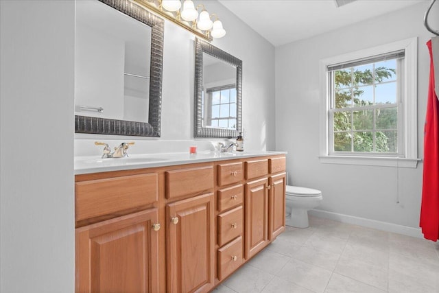 bathroom featuring vanity, tile patterned floors, and toilet