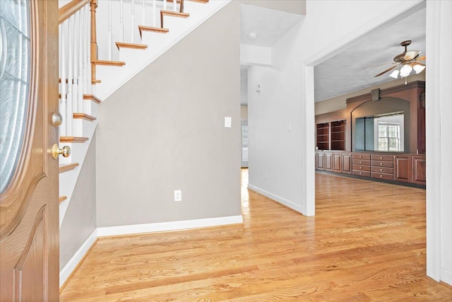 entryway with ceiling fan and light hardwood / wood-style flooring