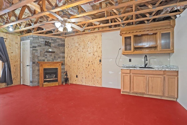 basement featuring sink and ceiling fan