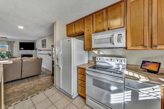 kitchen with white appliances and a textured ceiling