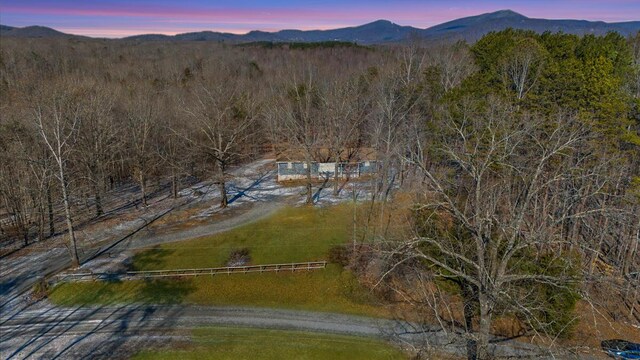 aerial view at dusk featuring a mountain view