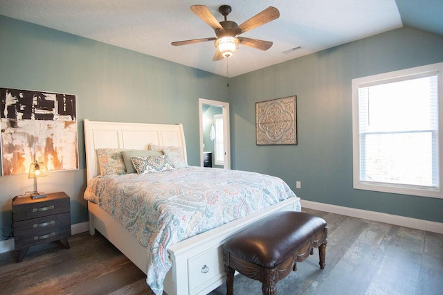 bedroom with ceiling fan, dark hardwood / wood-style flooring, and vaulted ceiling